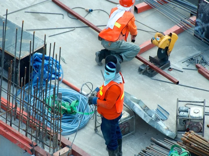 Construction workers in safety gear on a building site