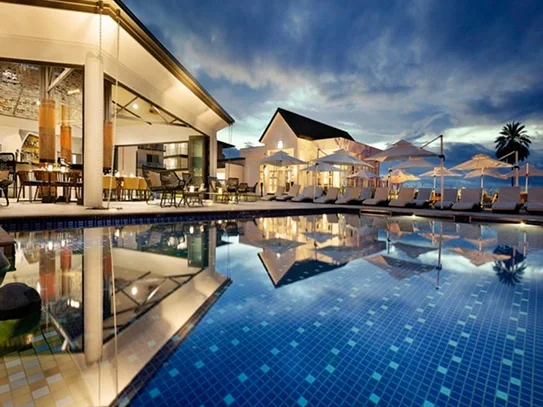 Hotel resort with a pool at dusk