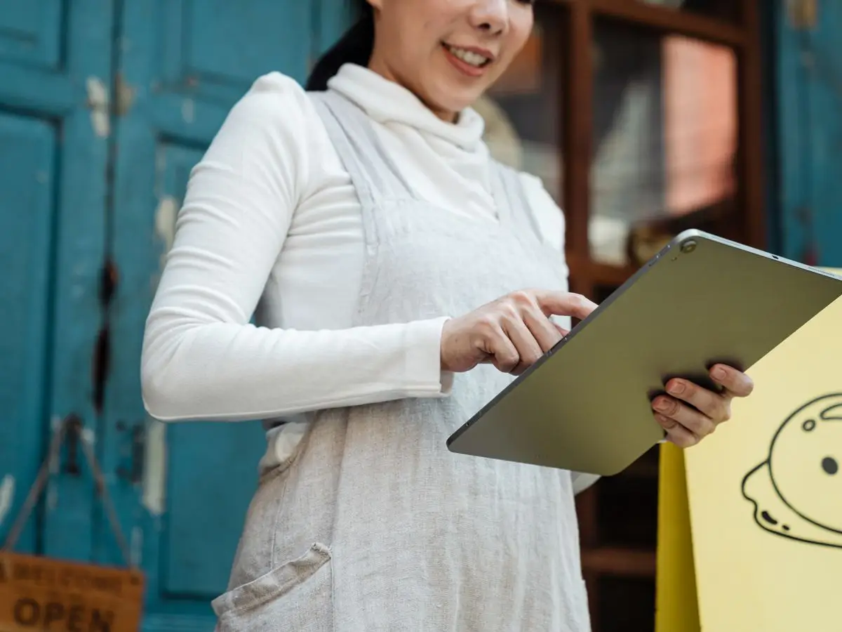 Shop owner checking orders on a tablet