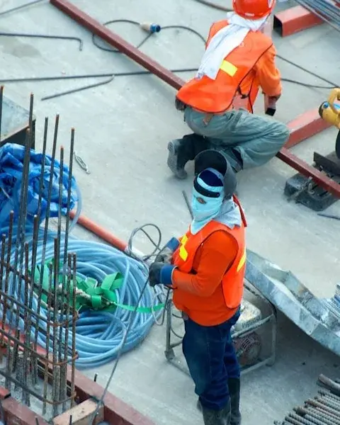 Construction workers in safety gear on a building site