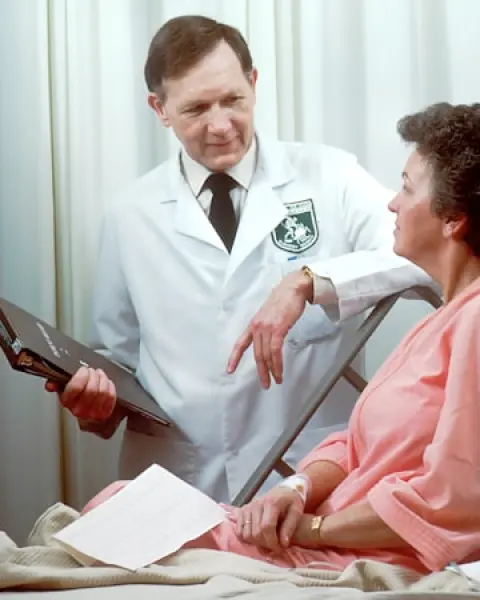 Doctor talking with a patient in a hospital room