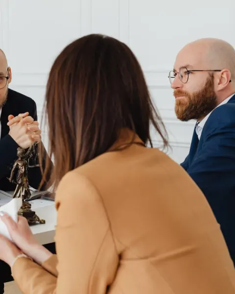 Lawyers meeting a client in their office