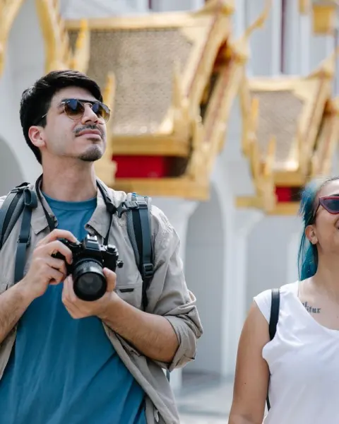Tourists with a camera visiting a temple