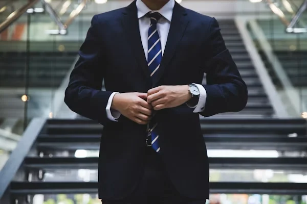 Independent advocate in formal legal attire prepared for client hearings