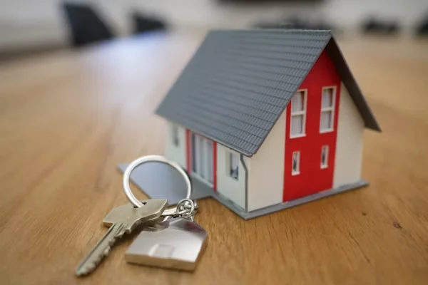 House model and keys representing property law and real estate conveyancing