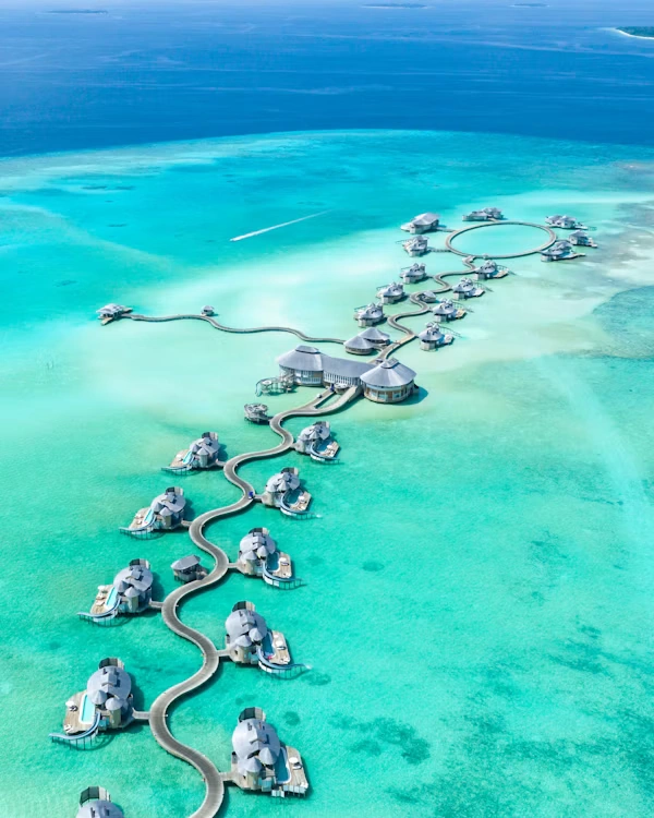 Luxury overwater villa resort in tropical turquoise waters